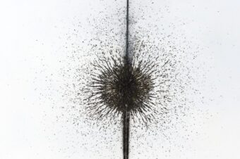 Field Concentration Close-up of iron filings densely gathered around a vertical magnetic axis