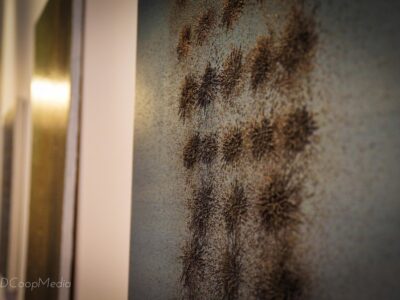 Field Array Installation view of repeated magnetic clusters formed by iron shavings across a panel surface