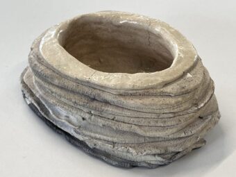 Layered Vessel Handbuilt ceramic vessel with layered horizontal bands, an irregular oval opening, glazed interior, and raw exterior surface.