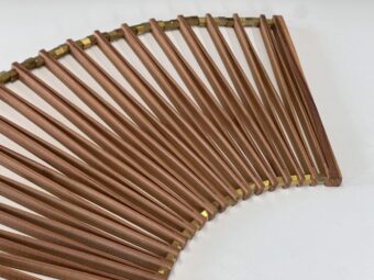 Articulated Form Fan-shaped wood sculpture with slotted wooden segments connected by brass pieces, viewed from above against a white background.